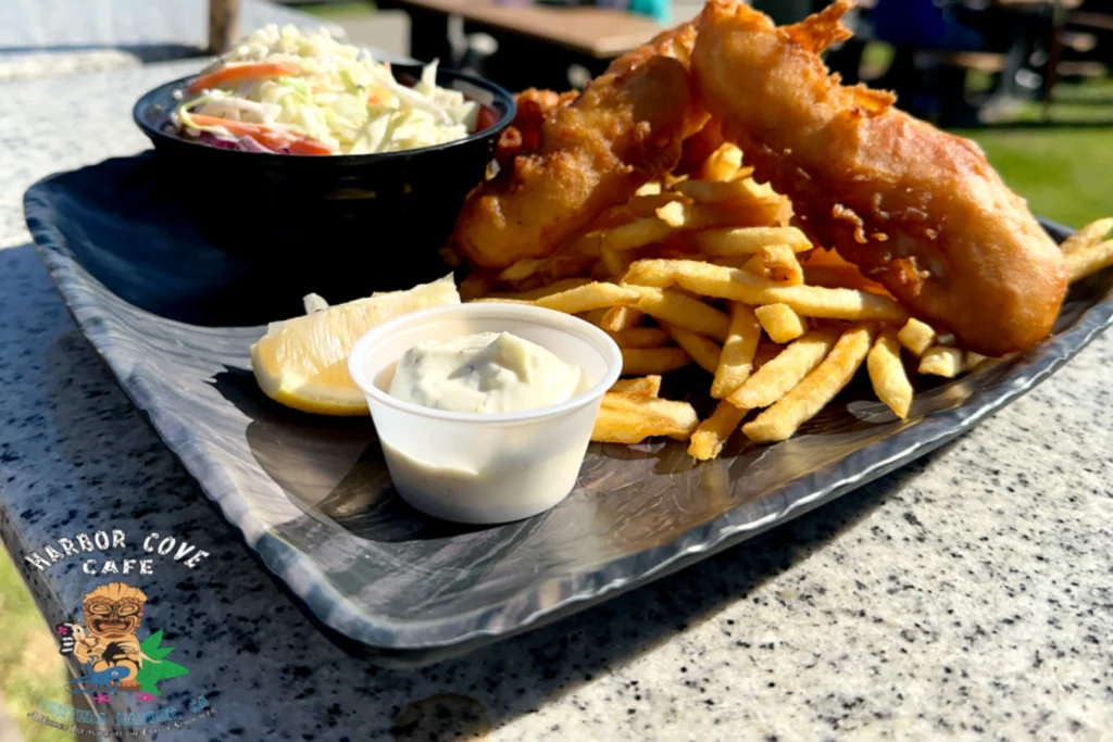 A plate of food with fish and fries on it